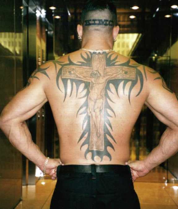  by carrying a giant wooden cross to the cage and with his cross tattoo.